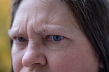 Furious woman staring aggressively, Middle-aged woman making disgusted face outdoors, Facial expression of discomfort, surprise, or awkward social situation, negative social situation