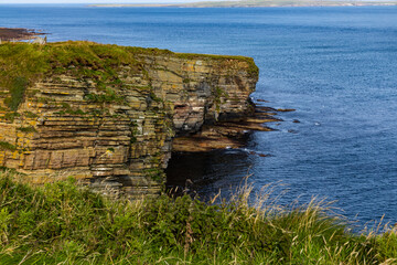 Duncansby Stacks, a breathtaking coastal wonder in Scotland, rise from the North Sea. Standing atop...