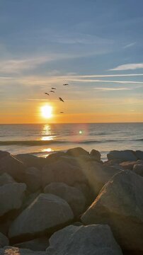 sunset over the sea with feeling like entering into the water and the sky has different color showing reflection into the wayer