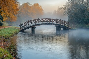 Serene Wooden Bridge Over Calm Misty River in Autumn