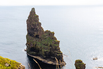 Duncansby Stacks, a breathtaking coastal wonder in Scotland, rise from the North Sea. Standing atop...