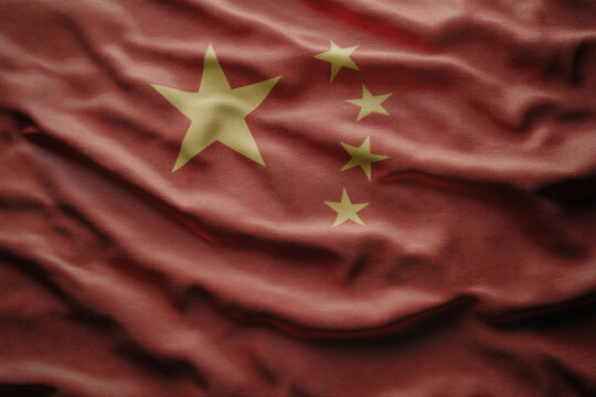 A close up of a red and yellow flag with stars