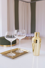 Elegant Cocktail Setup with Gold Cocktail Shaker and Glasses