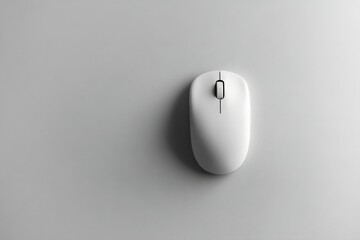 Clean white computer mouse placed on a smooth gray surface for minimalistic workspace aesthetics