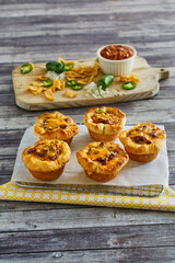 cornbread cups stuffed with ground beef, melted cheese, and green onions
