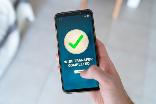 Wire transfer completed notification on smart phone. Concept of online banking.