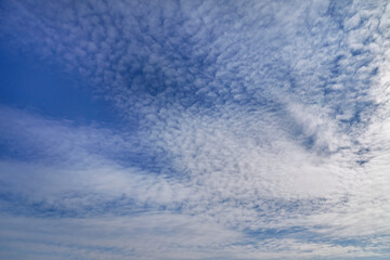 Light cloud patterns create texture in the sky, adding vibrancy to the landscape. Symbolizes...