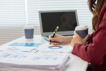 Businesswoman reviewing high-risk market analysis and investment documents for efficiency