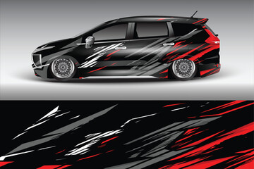 Obraz premium Stylish black car with dynamic red and gray graphics parked against a soft gradient background