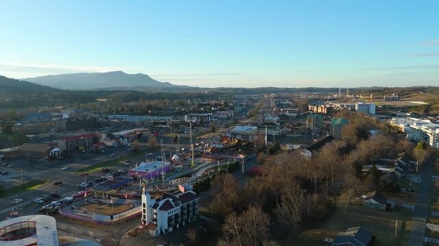 Piegon Forge, TN aerial push in over amusement parks at sunset.