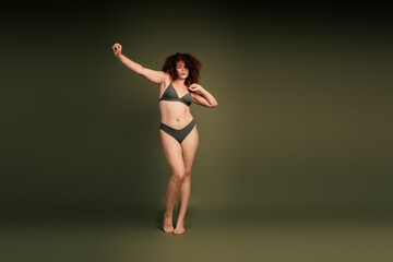 Beautiful young woman in natural light posing confidently, embracing her individuality and...