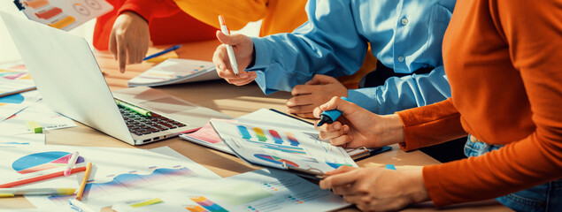 Startup company employee working together, analyzing BI dashboard paper on financial data report...