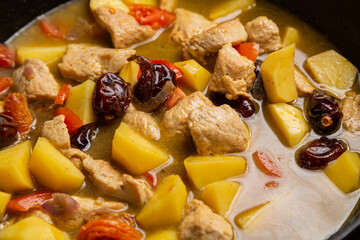 A rich chelnt with potatoes, beans, onions, meat, spices and dates is stewed