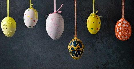 Hanging Easter eggs with beautiful colours and vintage background.,