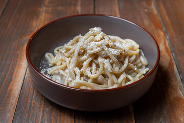 Traditional Italian pasta cacio e pepe in a ceramic bowl