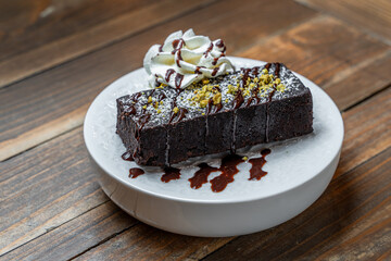 Decadent chocolate brownie with whipped cream and chocolate drizzle