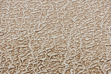 Close-up of wet sand and dust conditions on a white car in the summer.
