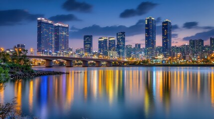 Obraz premium Illuminated cityscape reflected on serene river at twilight hour