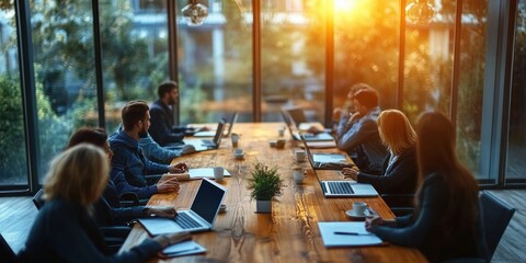 Top View of Busy Professionals Collaborating in Modern Office Meeting Room with Laptops and Coffee