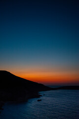 Sunset in a bay near Sitia, Crete, where the last colors of the day are reflected in the sea