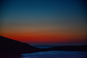 Fototapeta premium Sunset in a bay near Sitia, Crete, where the last colors of the day are reflected in the sea
