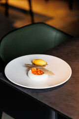 haute cuisine concept dessert in white plate on grey stone background