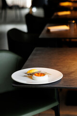 haute cuisine concept dessert in white plate on grey stone background