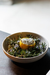 haute cuisine concept dessert with lemon rosmarinus sorbet  in white plate on grey stone background
