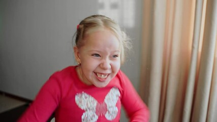 Excited young girl raising her arms with mouth wide open, expressing frustration and dissatisfaction. Child showing irritation, anger, and playful emotions. Close-up of emotional reaction and energy