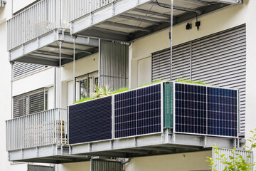 Fototapeta premium Balcony Solar Panel of Modern Apartment Building. Balcony Solar Power Plant. Photovoltaic Panels on Balcony Railing. 