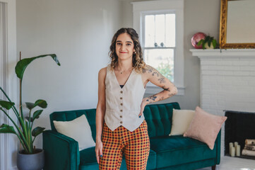Young Tattooed Woman Standing in a Living Room