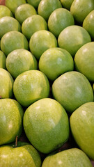 Variety of fresh apples on the supermarket counter. Apples for sale in the supermarket. Ripe juicy apples close-up with selective focus. Fruits. Heap of apples for sale in the store