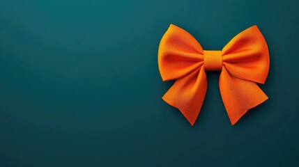 Bright orange bow standing out on a sleek deep green background