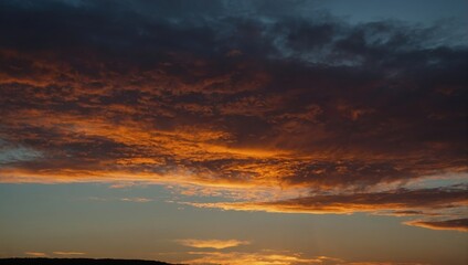 Fototapeta premium Striking Sunset Panorama: Fiery Clouds and Tranquil Sky in a Dramatic Sky-scape