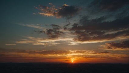 Fototapeta premium Vivid Skies: Dramatic sunset over distant horizon, orange and dark clouds create a warm and peaceful evening scenery