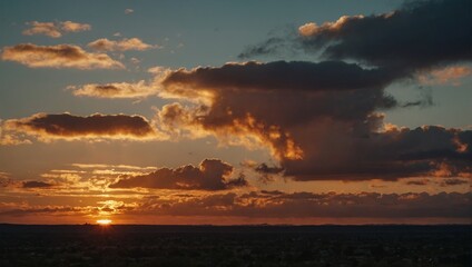 Dramatic Sky and Clouds at Sunset Over a Dark Landscape with Golden Light