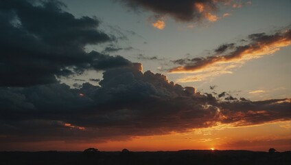 Fototapeta premium Dramatic sunset landscape with sunbeams piercing through storm clouds and orange sky over a dark horizon.