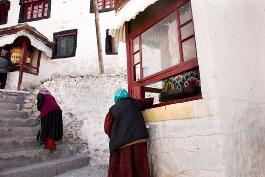 Tibetan pilgrim people walk on stone stairs step up approach to Diskit Monastery Galdan Tashi Chuling Gompa in Hunder or Hundar village of nubra tehsil valley at Leh Ladakh in Jammu and Kashmir, India