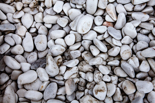 Pebbles on the ground as an abstract background. Texture. Granite 