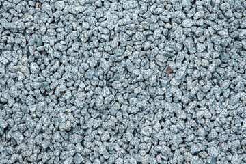 Pebbles on the ground as an abstract background. Texture. Granite 
