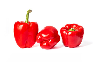 Three red peppers on a white background