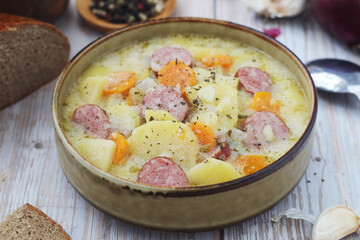 A bowl with traditional German potato soup with sausages