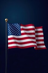Obraz premium American flag waving on flagpole against dark blue background