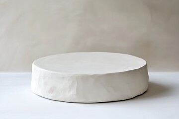 A white round empty podium made of soft textured material with rounded edges, Mockup scene for product presentation
