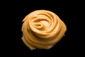 Delicious and healthy peanut butter on black background	