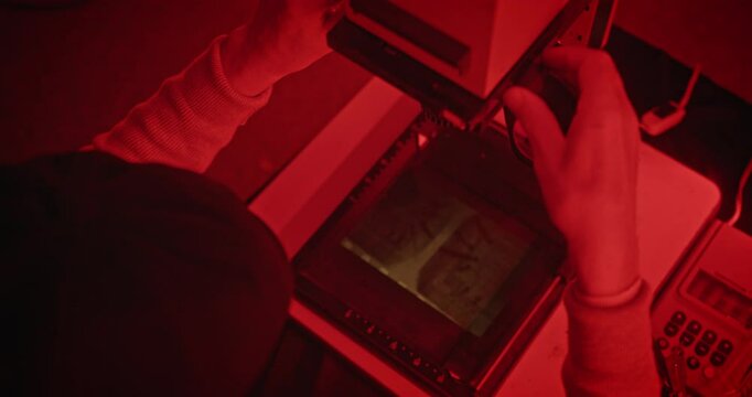 Exploring Red Light Photography Techniques in a WellEquipped Darkroom Setup Environment