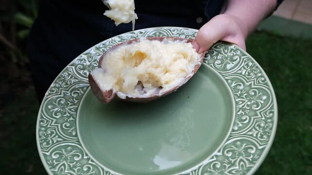 Confectioner showing the creaminess of the coconut fudge filling.
