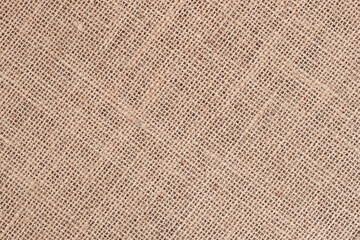 Texture of natural canvas, sackcloth or burlap. Rustic burlap fabric texture with coarse fibers and visible weave. Natural organic background for eco friendly and craft projects