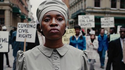 Determined African-American Woman Leading Civil Rights March in Historic Neighborhood, Advocating for Justice and Equality in a Peaceful Demonstration