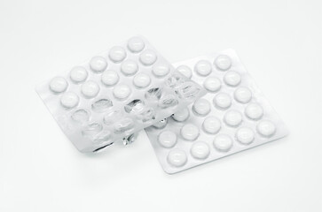 White Pills in Blister Packs on White Background